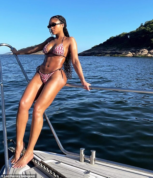 Rest and relaxation: Lori Harvey, 25, showed off her bikini bod as she toured Rio de Janeiro on Monday, looking relaxed in a red and white bikini