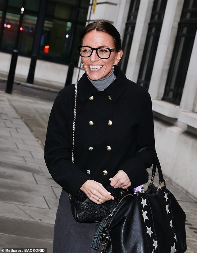 Monochrome: Davina donned a pair of tailored gray slacks with a turtleneck in a lighter shade, adding a blazer with gold button detailing on top.