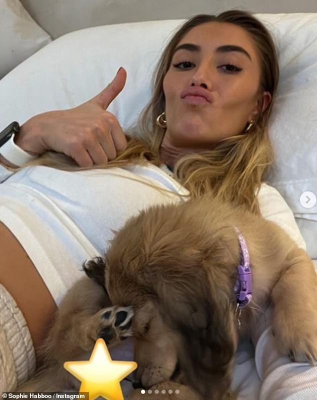 Cuddles: Sophie posted a snap of herself lying next to Bobbie as she enjoyed snuggling up to the sleeping pup on Saturday