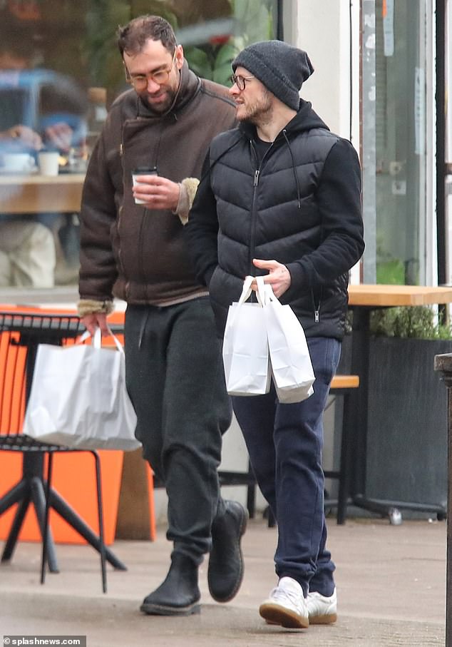 Friends: Kevin rocked a gray beanie, black hoodie and puffy jacket paired with blue sweatpants and appeared in deep conversation on Saturday