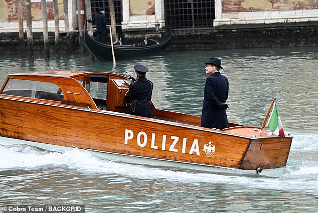 Detective duties: The actor climbed into a wooden police gondola while filming some solo scenes through the canals of the Italian city.