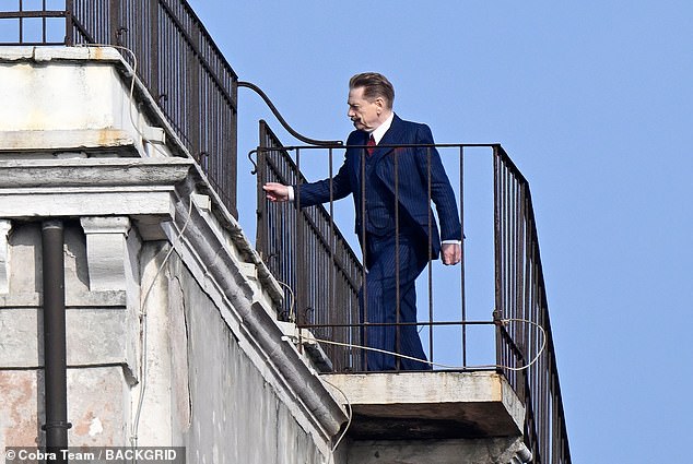 Up High: Kenneth was seen climbing onto a high balcony for the scenes.