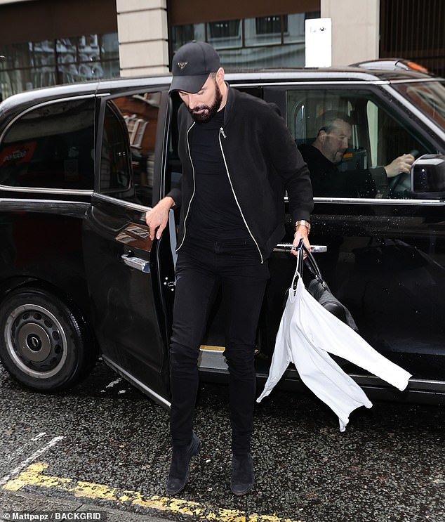 Designer: She layered a zip-up jumper over it and added some couture with a Prada baseball cap, which retails for around £300.