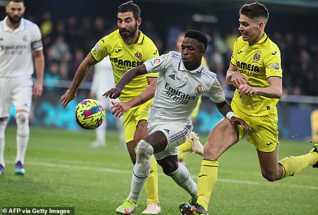 After a long VAR review, Foyth seemed to pass a through ball to Madrid's Vinicius Junior (L)