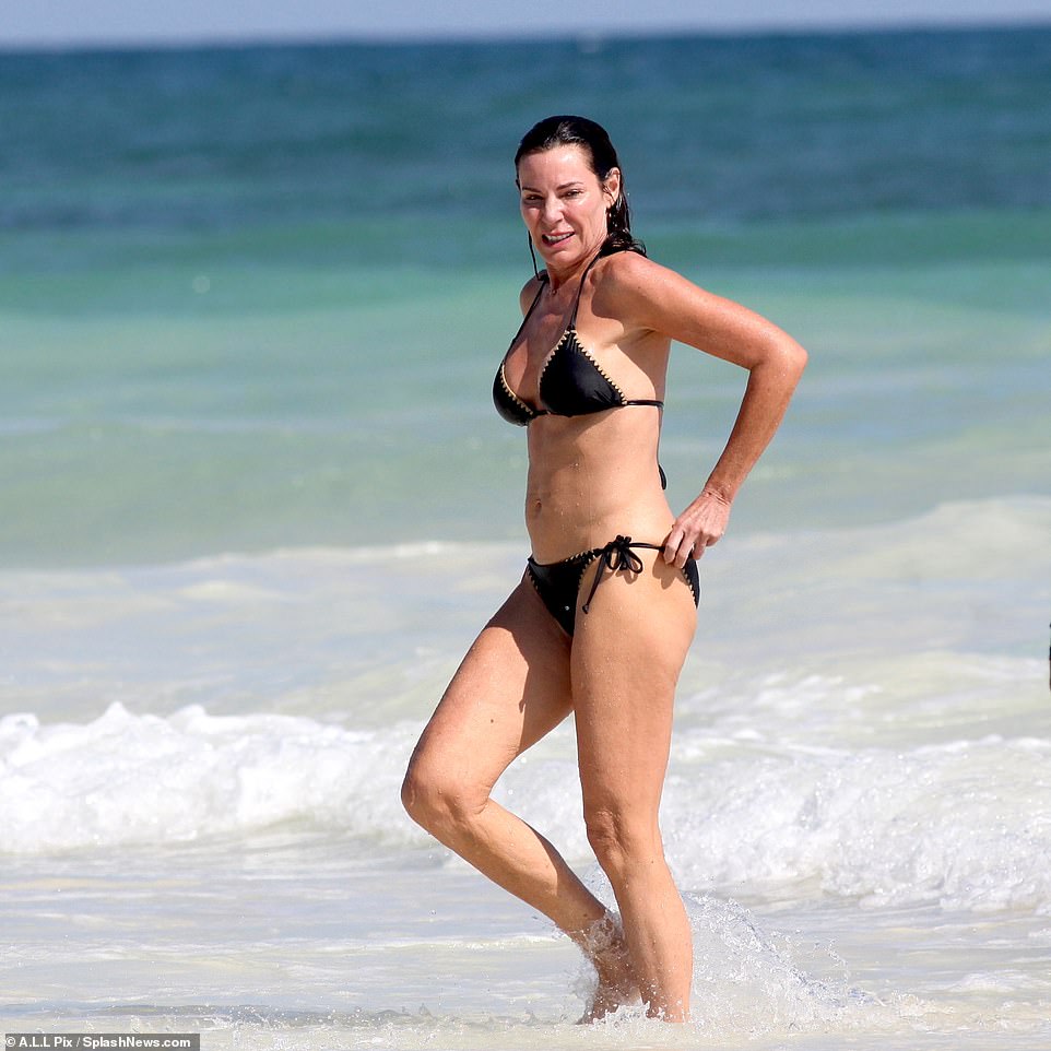 Stunning physique: The TV personality showed off her fit body wearing a black lace-up bikini during her day at the beach