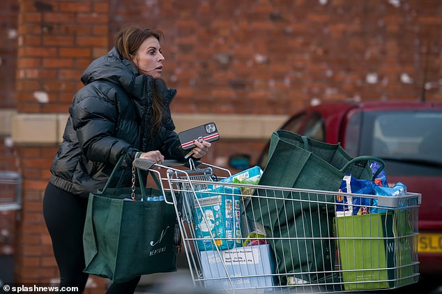 Practical: WAG, 36, reportedly worth £120m with her football husband Wayne Rooney, also kept her reusable Waitrose bags when she walked into the low-budget supermarket