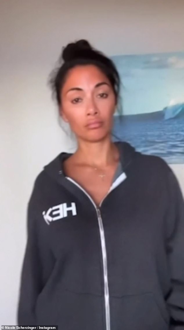 Low-key look: The video began with Nicole dressed in a casual hoodie while she went makeup-free and wore her raven locks in a messy bun