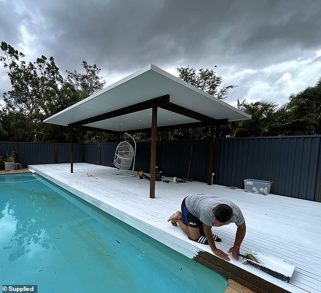 The first step was to clean the deck, followed by a power wash on the wood and then three coats of white paint (pictured during)