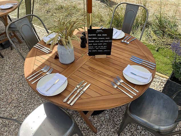 Wooden tables adorn the exterior of the Diddly Squat restaurant which Jeremy Clarkson opened in July 2022