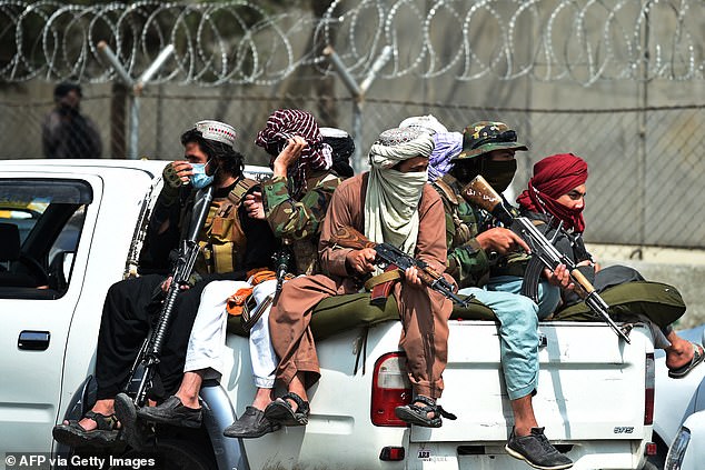 Taliban fighters keep watch outside the Kabul airport on August 31, 2021.