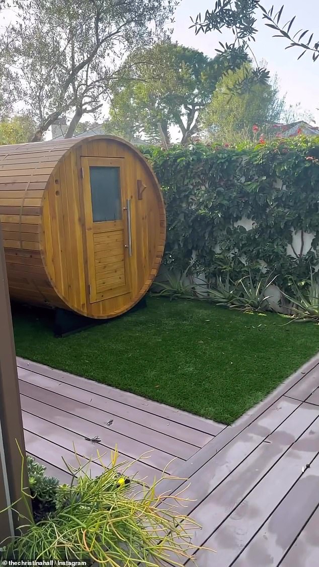 Sauna time: She then showed off her relaxing sauna cabin, a structure made of wood with a bench that she sat on while sweating in her sports bra and spandex shorts.