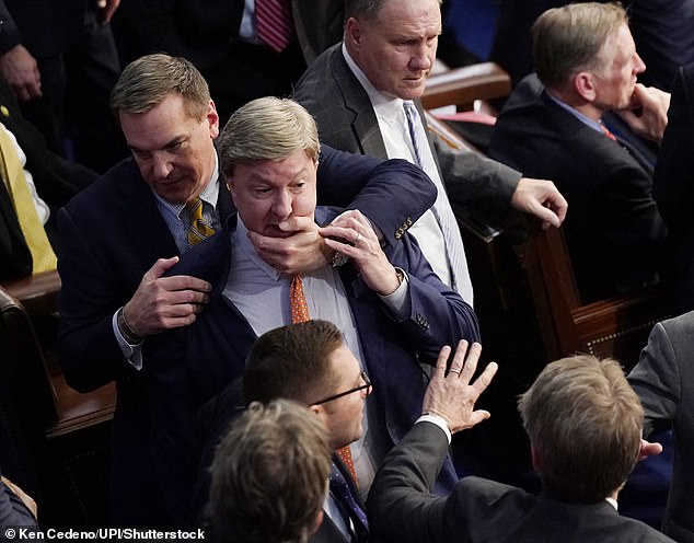 After taking the night to its 15th voting session, US Representative Mike Rogers appeared to attack Gaetz, and Congressman Richard Hudson stopped him (above).