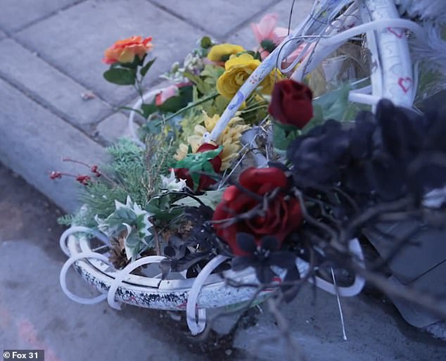 The ghost bike is laced with flowers, all entwined inside the wheels, along with a picture of Rocklin.