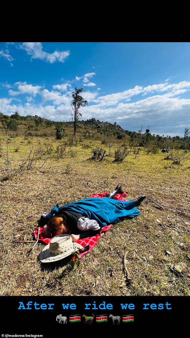 Lying down: Madonna lay down in a field after a long journey