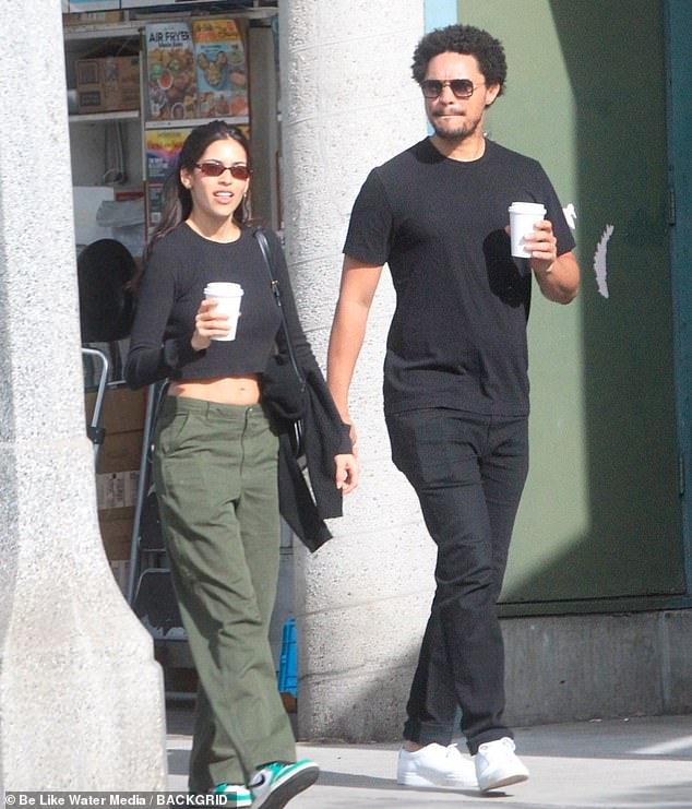 Coordinated: Trevor and his partner held latte mugs and each wore sunglasses as they hung out in Tinseltown