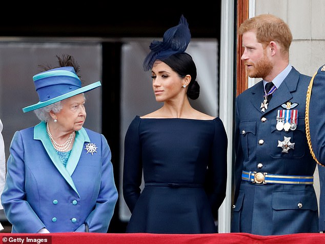 Pictured: Queen Elizabeth II, Harry and Meghan watch a flight to mark the centenary of the Royal Air Force from the balcony of Buckingham Palace on July 10, 2018.