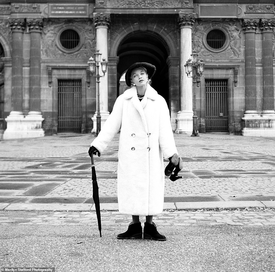 Marilyn Stafford photographed a model holding her heels and an umbrella, while wearing flat boots, after a fashion shoot at the Louvre, circa 1955.