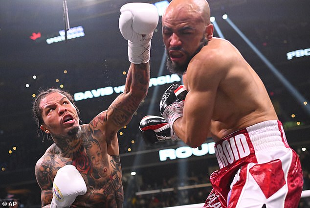 In the actual fight, Davis (left) continued his undefeated record by stopping Hector Luis Garcia