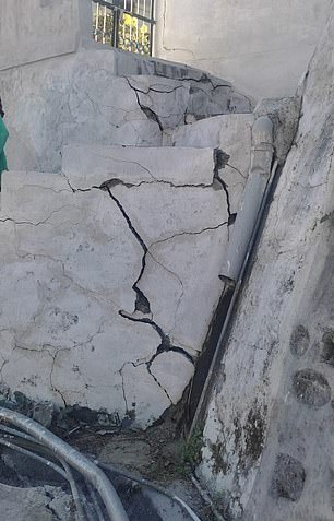 A large crack in the side of a building.