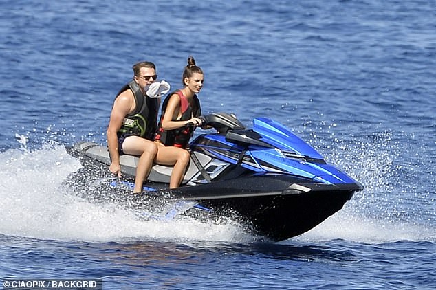 Fun in the sun: Leo and his ex Camila looked like they were having the time of their lives as they settled in on a jet ski during another yacht trip in Ponza, Italy (pictured December 2019)