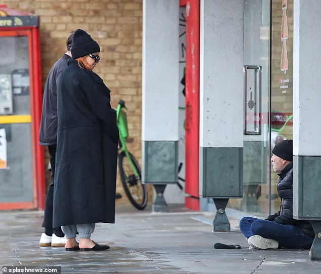 Chat: The couple chatted animatedly, before stopping for a moment to talk to a homeless man.