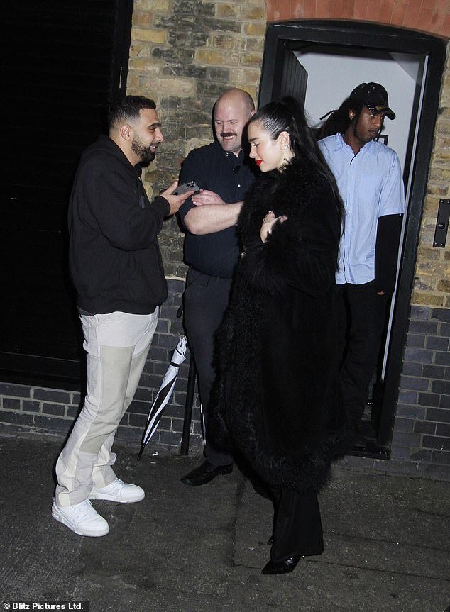 Off I go: The singer also donned a pair of black heels for a night out in London as she left the exclusive venue on Saturday night