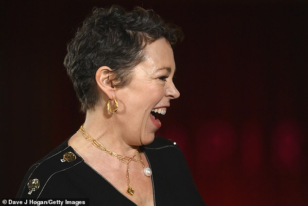 Good times: The actress, 48, opted for a long black dress to mark the occasion, which was punctuated by white stitching and gold buttons on each shoulder