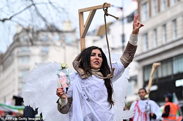 Protesters pose in a mock gallows as they gather in central London on Sunday, January 8, 2023.