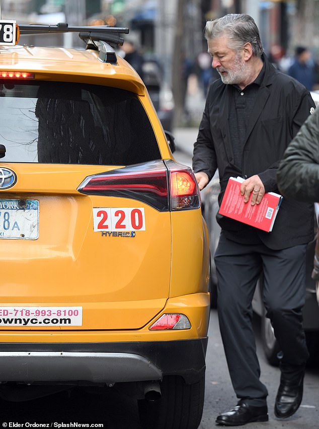 Your car awaits: Baldwin was carrying some reading material when he got into his cab.