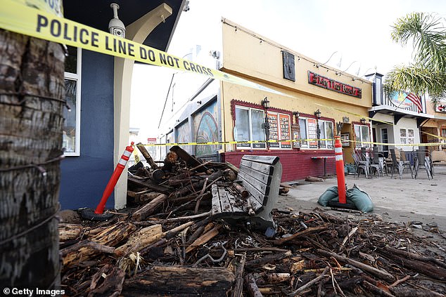 Debris is seen piled up in front of a restaurant after a massive storm hit the area on January 6 in Capitola, California.