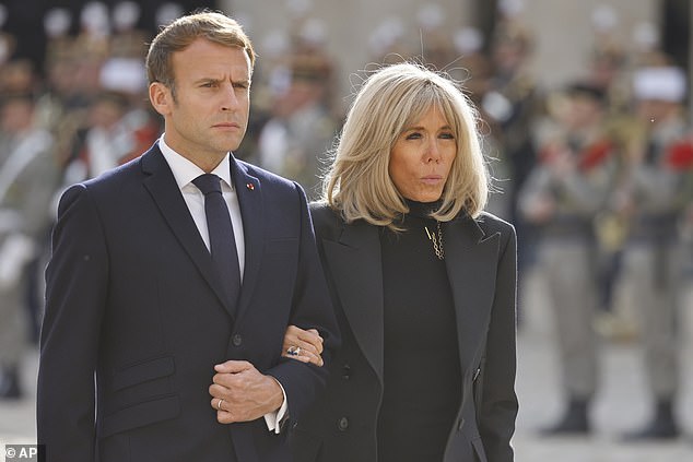 French President Emmanuel Macron and his wife Brigitte Macron attend a national memorial service for Hubert Germain at the Hotel des Invalides in October 2021.