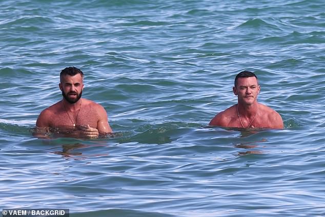 Just keep swimming: The shirtless star bared his toned torso in a pair of skimpy black briefs, while his partner opted for a similar pair in bright turquoise.