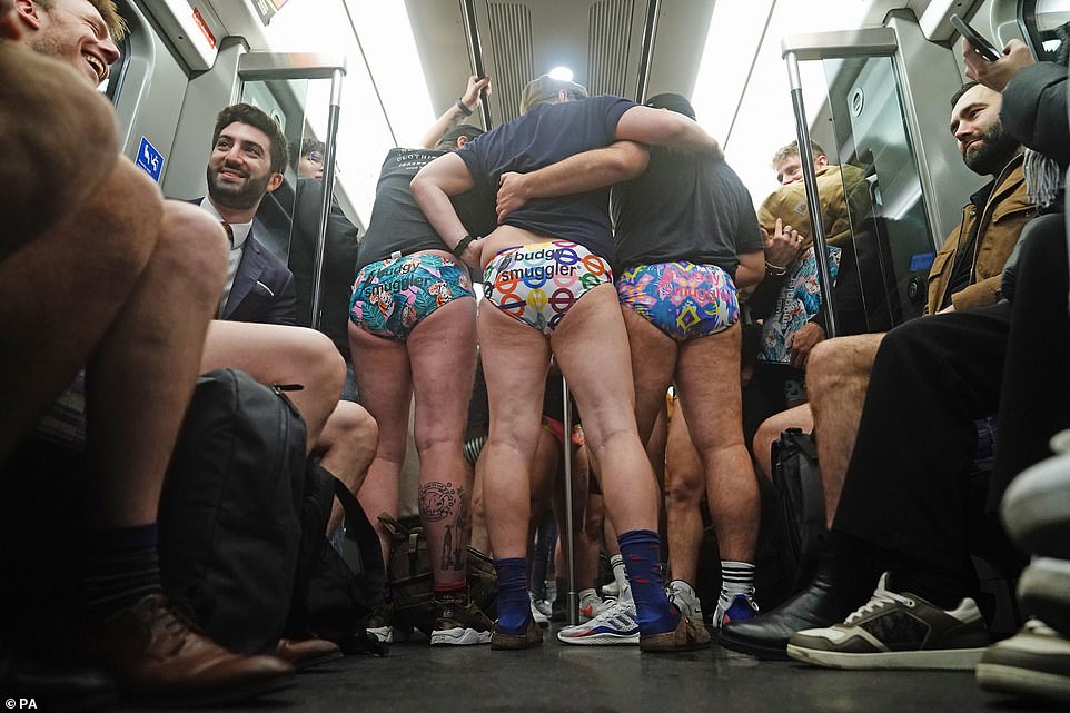 Three travelers don shiny underwear to join others, including the fully clothed, for the 12th annual no-pants tube ride.