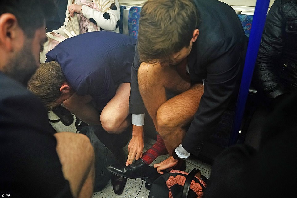 A crush and a squeeze: Some struggled to remove their pants while riding the subway.