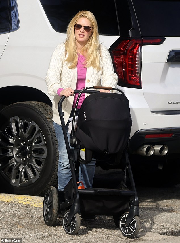 Pushing the stroller: Heidi, who told ET she'll never get pregnant again, looked comfortable in a white cardigan over a pink long-sleeved top and blue jeans