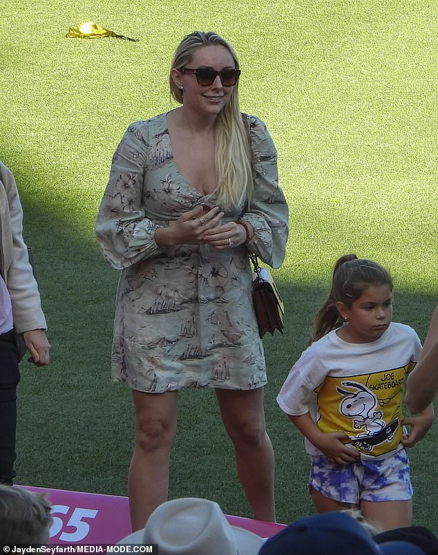 Steve Smith's wife, Dani Willis (pictured), showed off her fit physique in a plunging floral mini-dress with long, bodice-style sleeves.