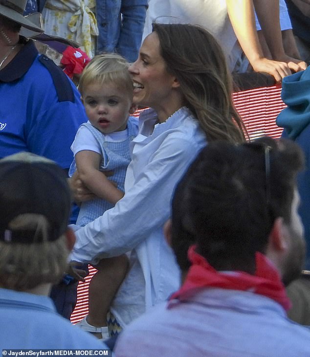 The glamorous brunette beamed with pride as she carried Albie and cheered on Pat after her team's big win.