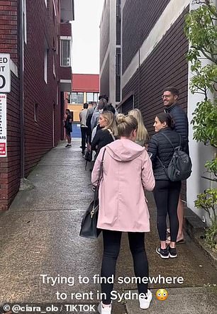 Many are seen waiting outside the unit on a cold and miserable day.