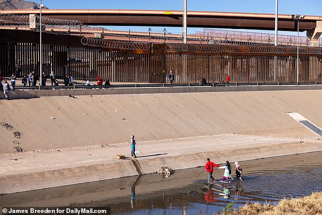 More than 100 migrants could be seen along the border fence waiting to be allowed in.