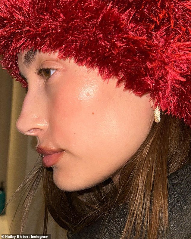 A splash of color: The Rhode founder also shared a close-up of herself modeling a striking red hat that partially covered her long locks