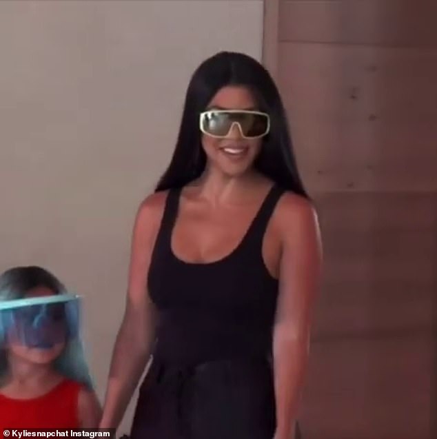 Perfect look: Kourtney showed up in a form-fitting black tank top and matching leggings with thick shadows covering her eyes