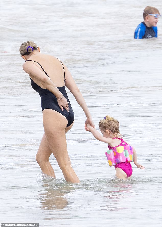 Jade's sister Jasmine wore a black bathing suit while taking a dip in the ocean with her two-year-old daughter Harper.