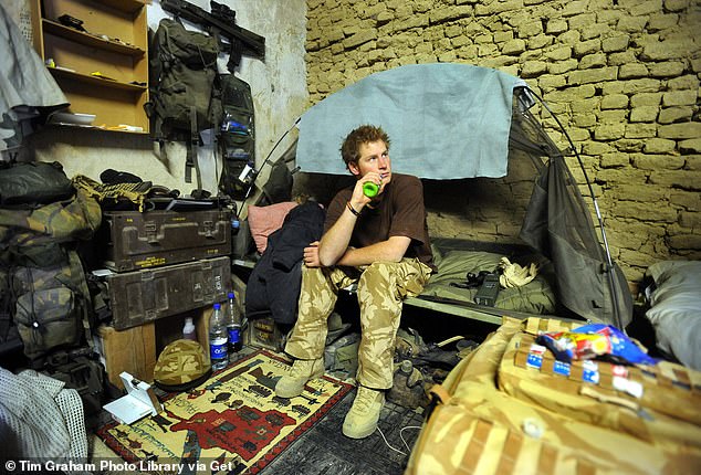 After shaking Colonel Ed's hand, Harry left his tent, packed up his belongings, and said goodbye to his comrades.  He then boarded a Chinook helicopter and an hour later was in Kandahar.  Harry is shown sitting on his cot at a forward operating base in January 2008.
