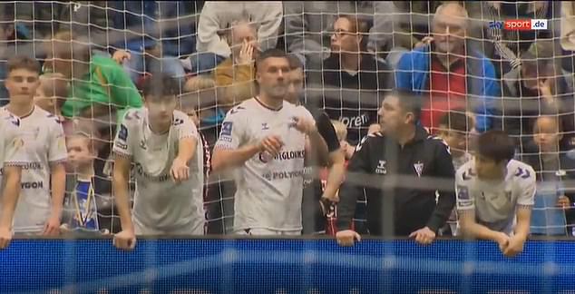 Podolski was outraged by the decision while standing on the sidelines with his teammates.