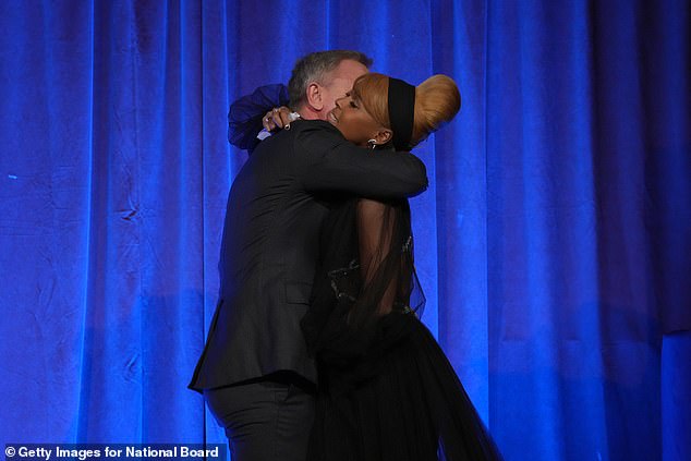 Hug: He handed the gong to the Hidden Figures star, 37, after they shared a warm hug on Sunday