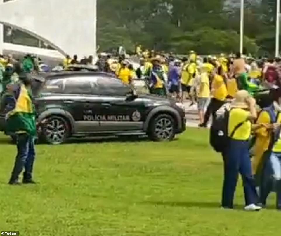 Newly emerged footage from the violent protests at the Brazilian capital showed a police car driving through crowds of demonstrators at dangerous speeds