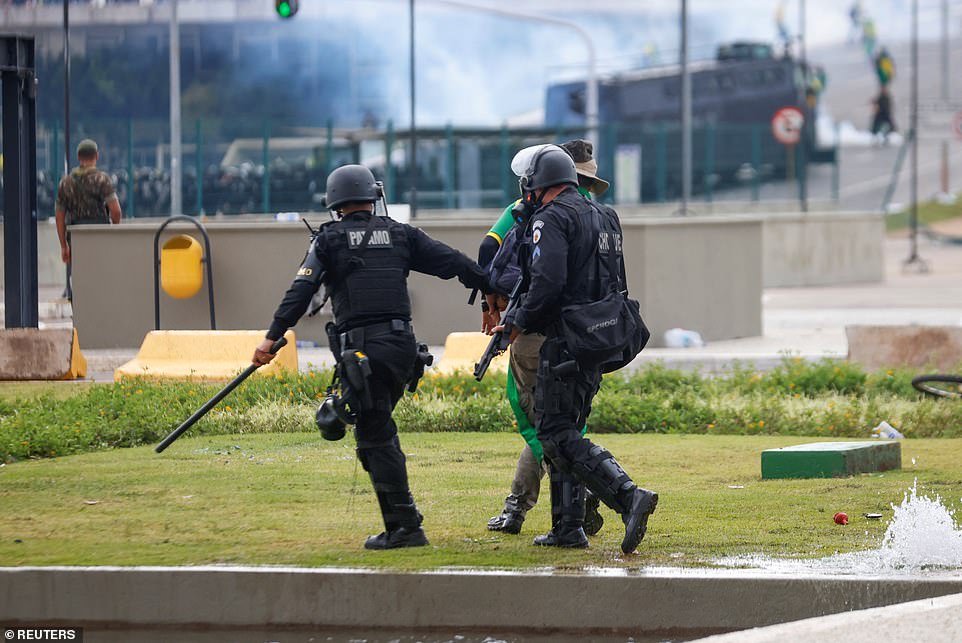 Officers take away a protestor during the violent demonstrations in Brazil on Sunday