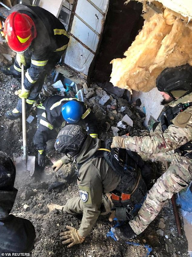 Rescuers dig through the rubble in the aftermath of the attack