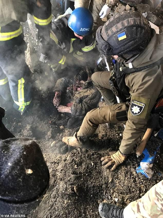 A photograph posted online by the Ukrainian president's office showed rescuers trying to pull a woman free of the dirt and debris following the missile attack