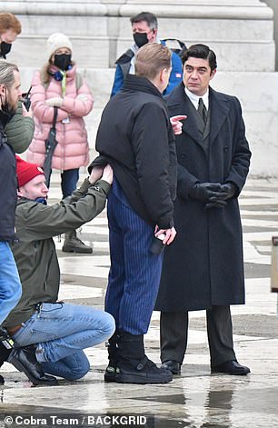 Quick Fix: A crew member adjusted Kenneth's costume and microphone under his blazer and jacket during a time out